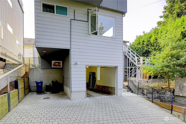 a view of couch on wooden deck with mountain view