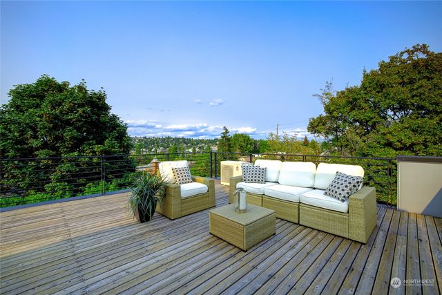 an aerial view of a houses with a yard and lake view