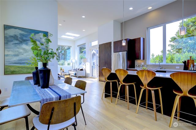 a living room with furniture dining table and wooden floor