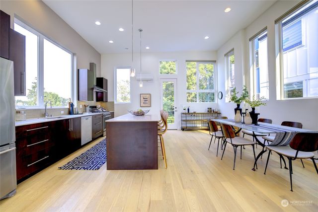 a living room with furniture a large window and a table