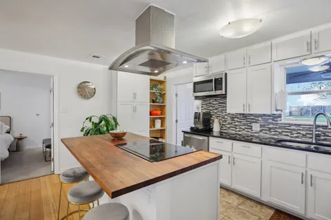 a kitchen with cabinets and stainless steel appliances