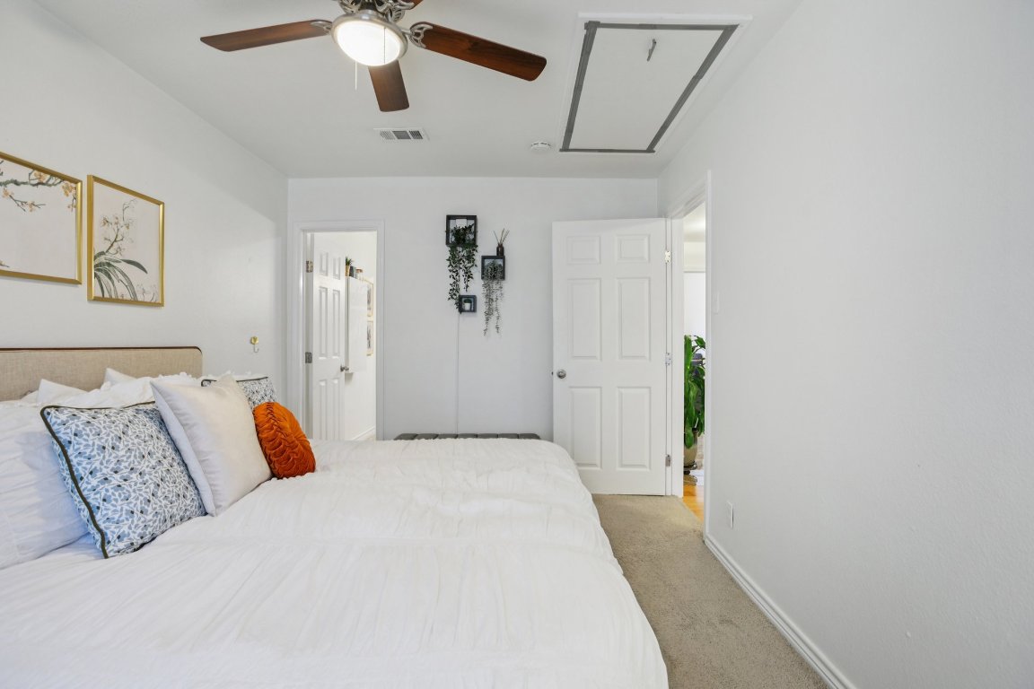 4413 Russell Drive Austin, TX 78704 - Photo 15 of 29 a bedroom with a large bed and a chandelier