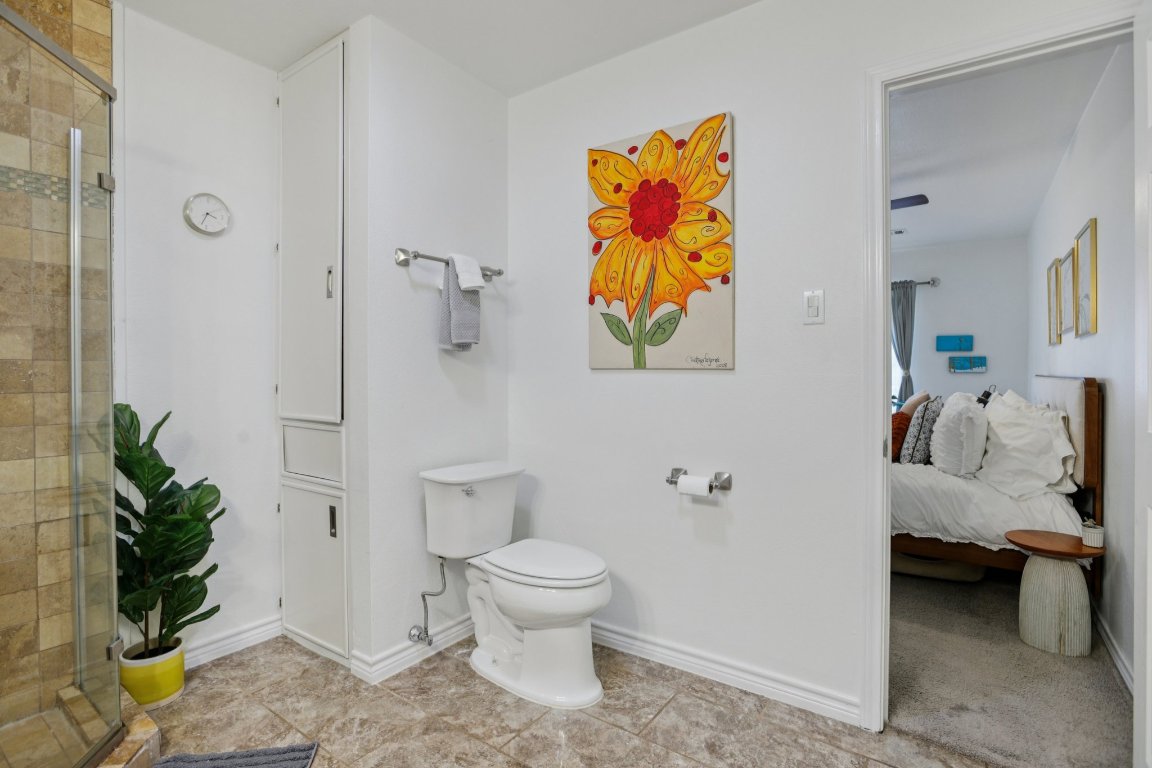 4413 Russell Drive Austin, TX 78704 - Photo 17 of 29 a bathroom with a toilet sink and shower curtain