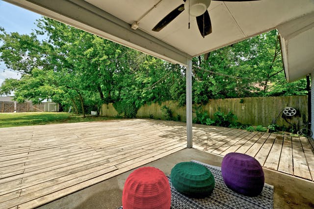 4413 Russell Drive Austin, TX 78704 - Photo 22 of 22 Wooden terrace featuring a patio, a fenced backyard, ceiling fan, and a storage unit