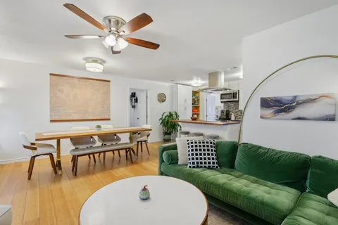 a view of a dining room with furniture and wooden floor