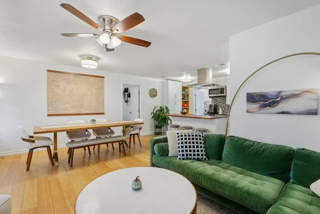 a view of a dining room with furniture and wooden floor