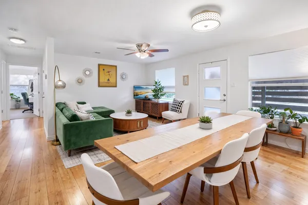 a kitchen with refrigerator and chairs