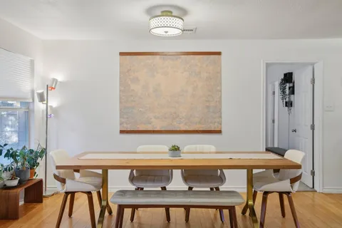 a view of a dining room with furniture and wooden floor