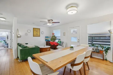 a living room with furniture and a wooden floor