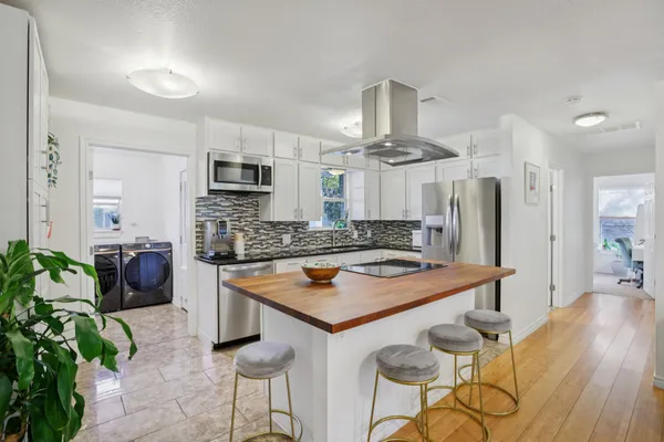 a kitchen with stainless steel appliances granite countertop a sink and cabinets