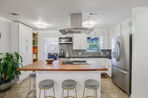 a kitchen with stainless steel appliances granite countertop a sink and cabinets