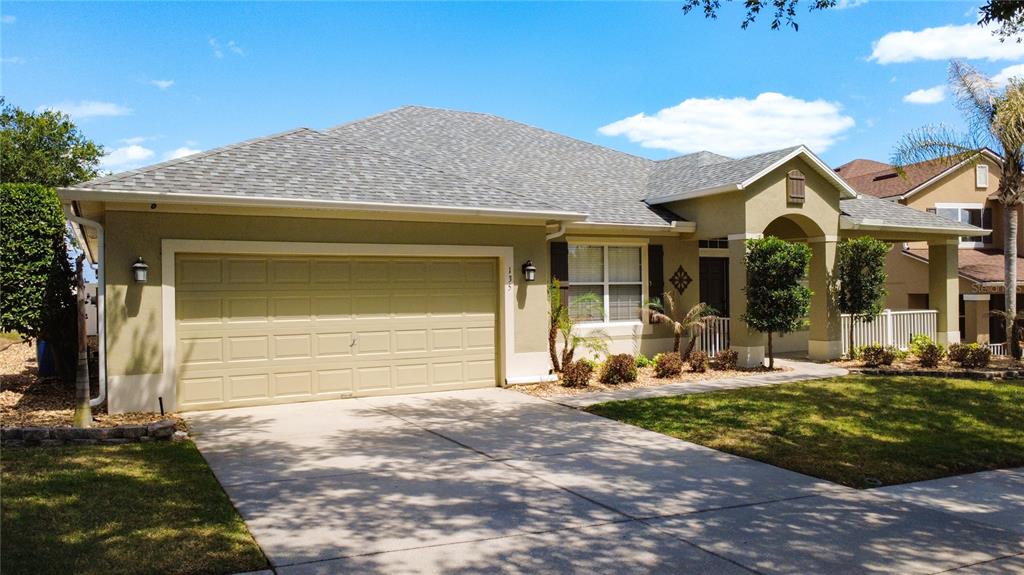 135 Blackstone Creek Road Groveland, FL 34736 - Photo 1 of 62 a front view of a house with a garden and yard