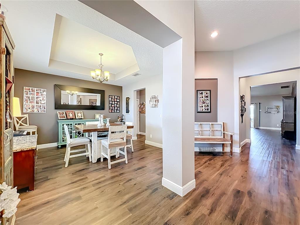 135 Blackstone Creek Road Groveland, FL 34736 - Photo 11 of 62 a view of a dining room with furniture and wooden floor