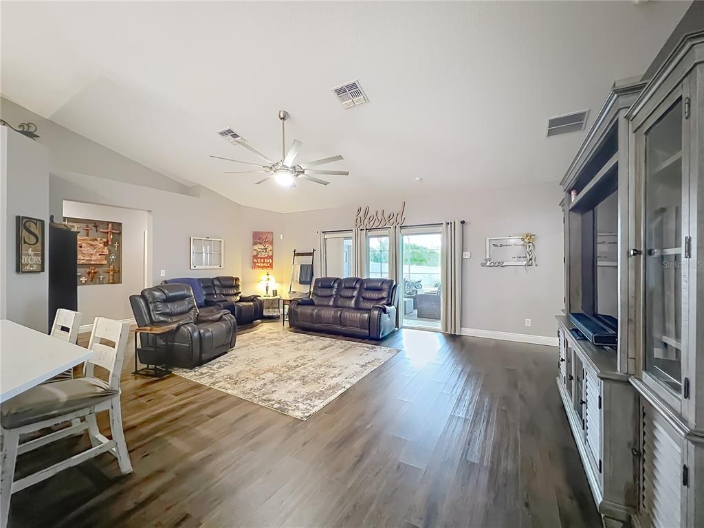 135 Blackstone Creek Road Groveland, FL 34736 - Photo 16 of 62 a living room with furniture and a flat screen tv
