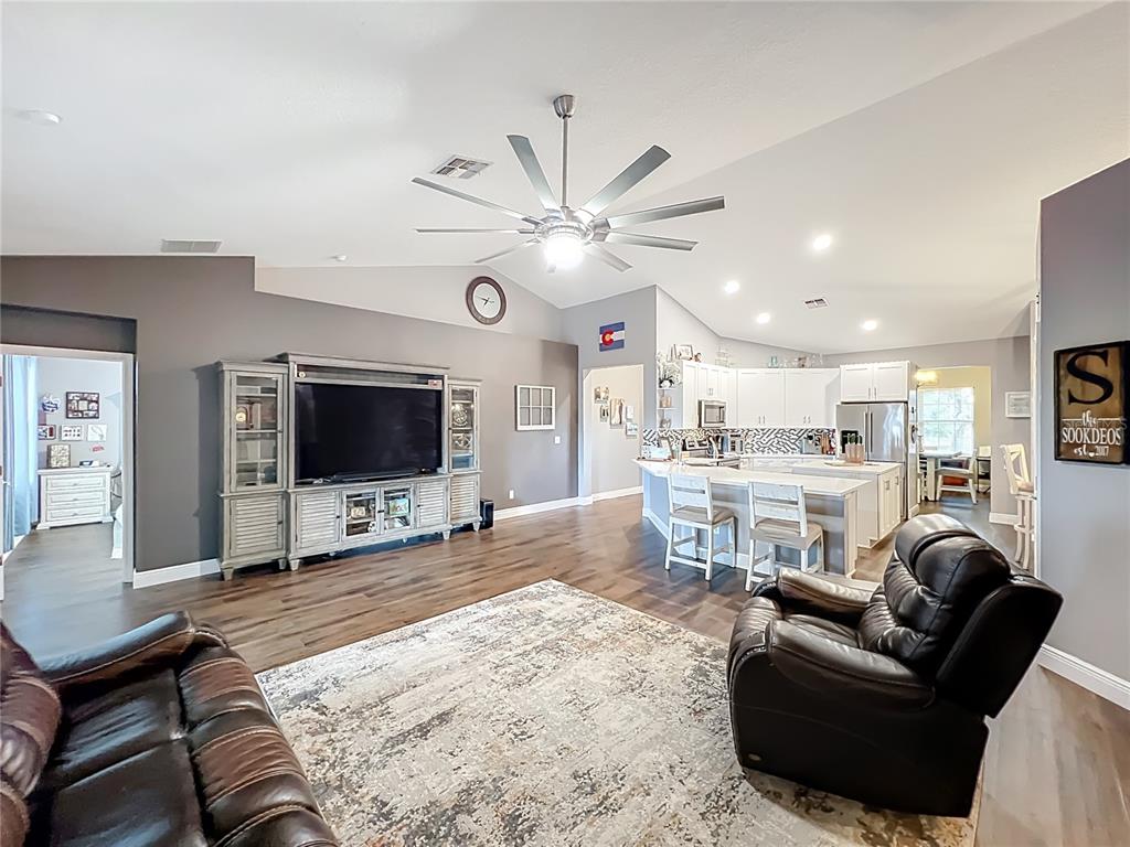 135 Blackstone Creek Road Groveland, FL 34736 - Photo 20 of 62 a living room with furniture and a flat screen tv