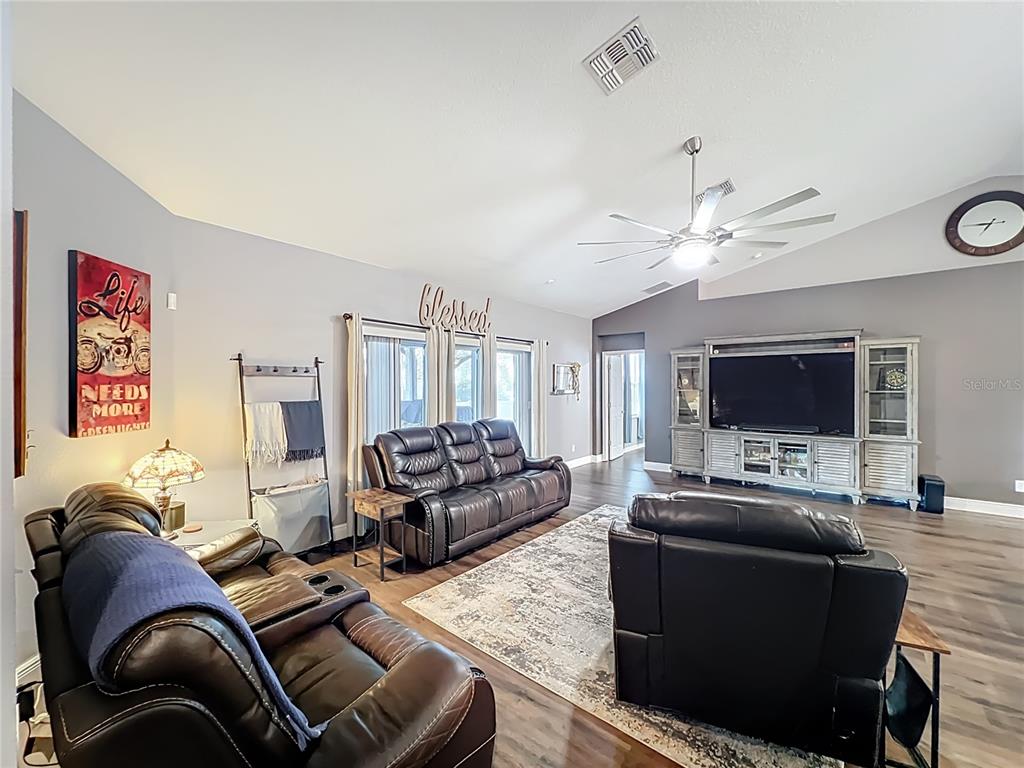 135 Blackstone Creek Road Groveland, FL 34736 - Photo 21 of 62 a living room with furniture and a flat screen tv