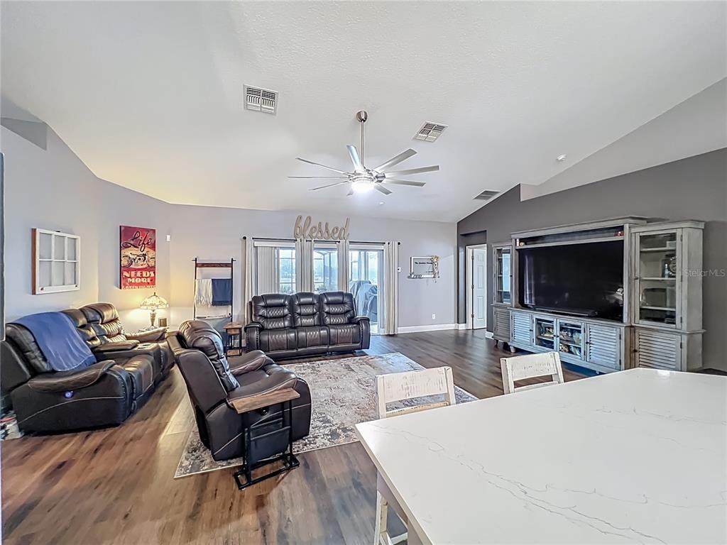 135 Blackstone Creek Road Groveland, FL 34736 - Photo 24 of 62 a living room with furniture and a flat screen tv
