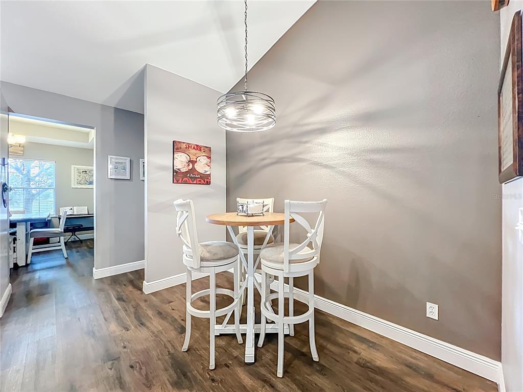 135 Blackstone Creek Road Groveland, FL 34736 - Photo 25 of 62 a view of a dining room with furniture and wooden floor