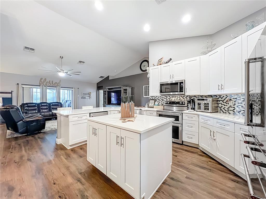 135 Blackstone Creek Road Groveland, FL 34736 - Photo 29 of 62 a kitchen with a sink stove and cabinets