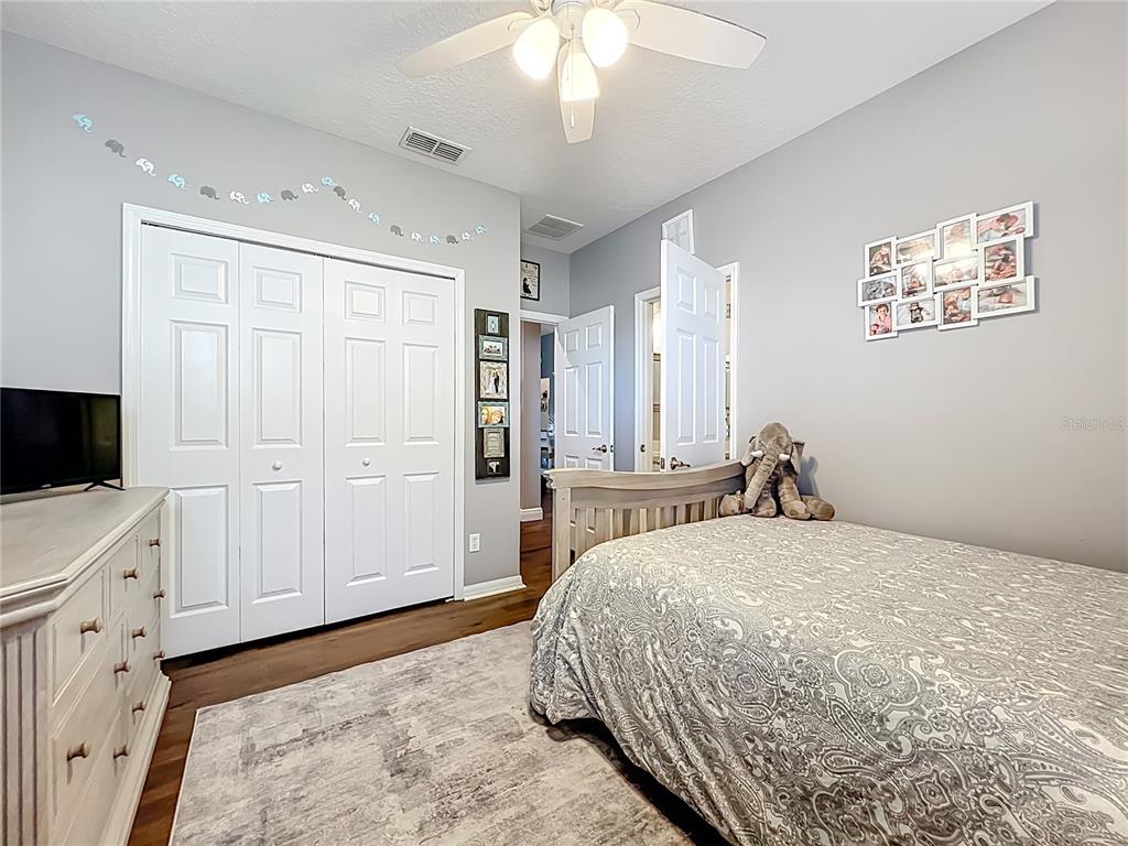 135 Blackstone Creek Road Groveland, FL 34736 - Photo 34 of 62 a bedroom with a bed and a flat screen tv