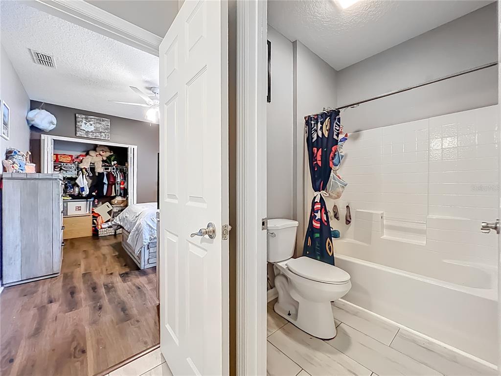 135 Blackstone Creek Road Groveland, FL 34736 - Photo 37 of 62 a bathroom with a toilet and a shower