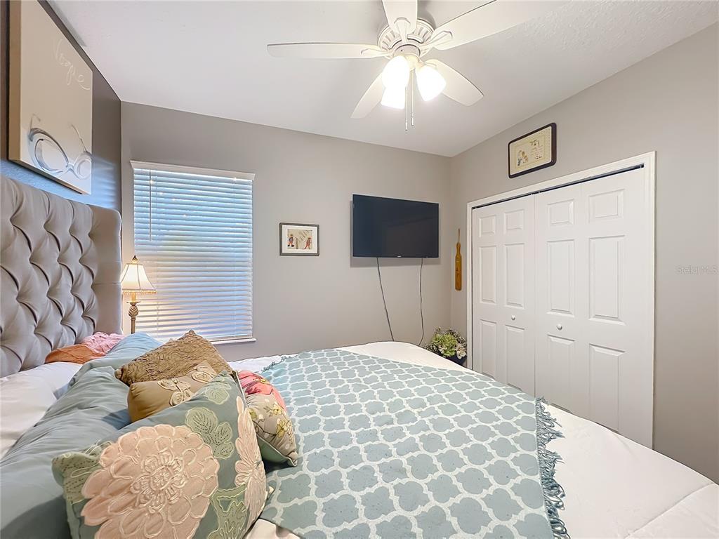 135 Blackstone Creek Road Groveland, FL 34736 - Photo 38 of 62 a bedroom with a bed and a flat screen tv