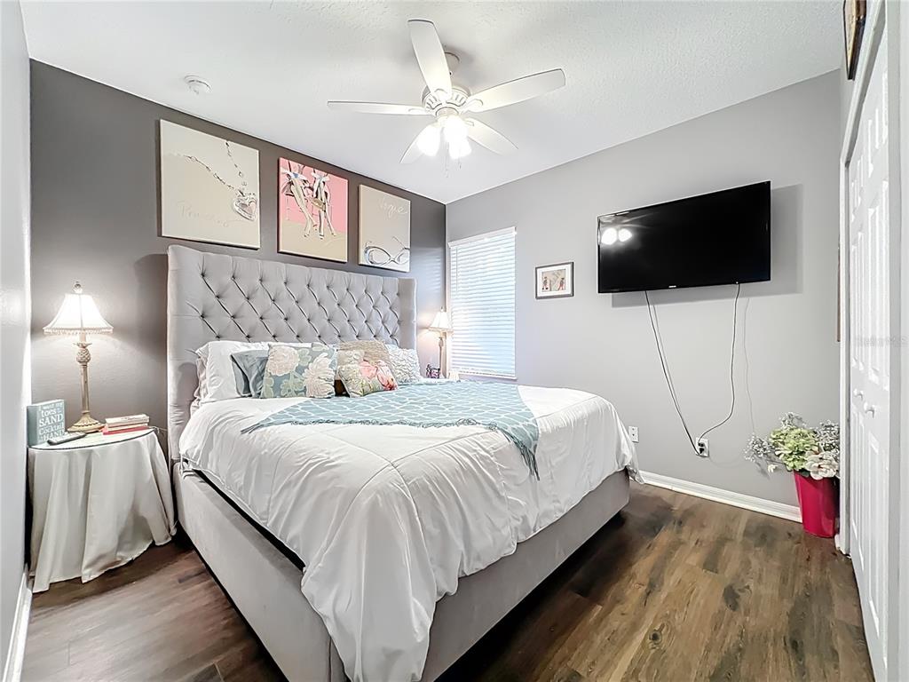 135 Blackstone Creek Road Groveland, FL 34736 - Photo 39 of 62 a bedroom with a bed and a flat screen tv