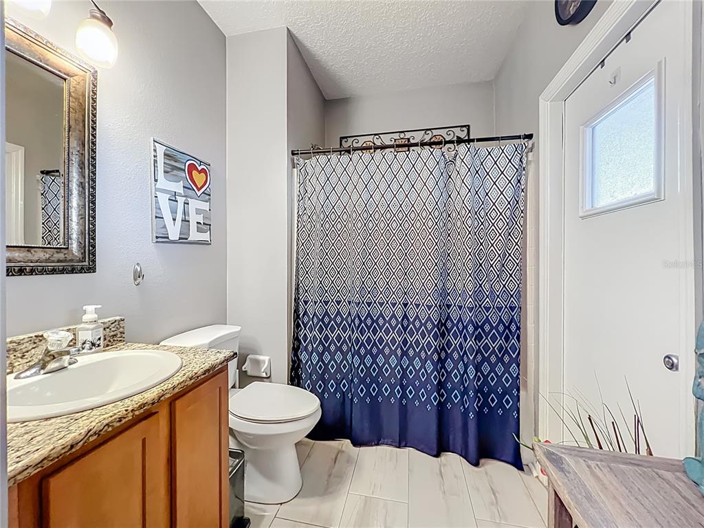 135 Blackstone Creek Road Groveland, FL 34736 - Photo 40 of 62 a bathroom with a sink toilet and shower