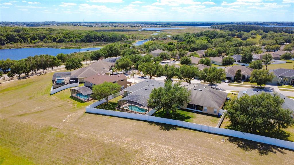 135 Blackstone Creek Road Groveland, FL 34736 - Photo 59 of 62 an aerial view of a house with a garden and lake view