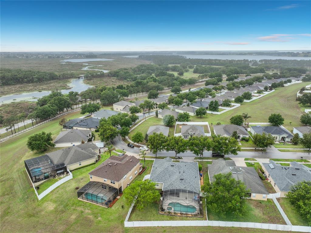 135 Blackstone Creek Road Groveland, FL 34736 - Photo 61 of 62 an aerial view of residential houses with outdoor space and ocean