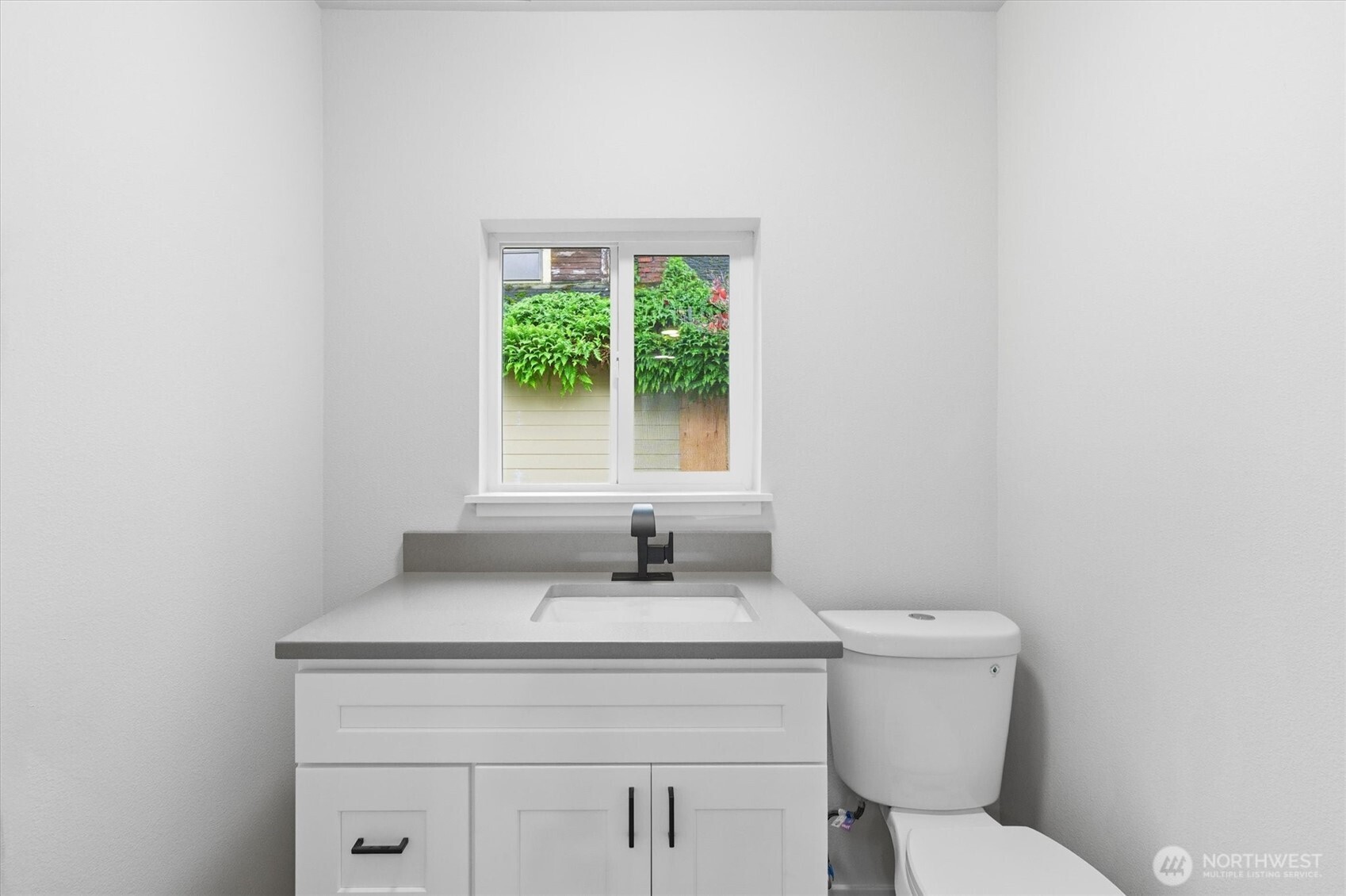 289 20th Avenue Longview, WA 98632 - Photo 19 of 38 a bathroom with a toilet sink vanity and window
