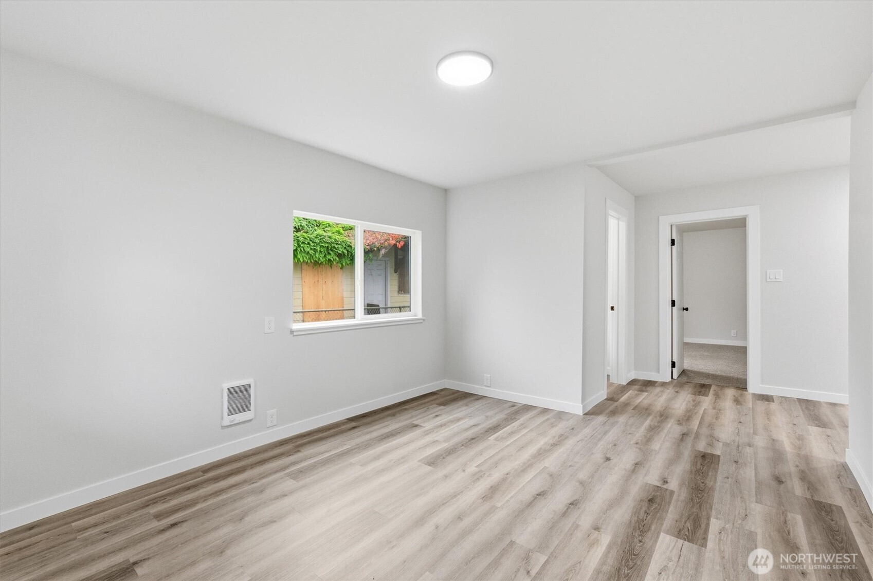 289 20th Avenue Longview, WA 98632 - Photo 5 of 38 a view of an empty room with wooden floor and a window