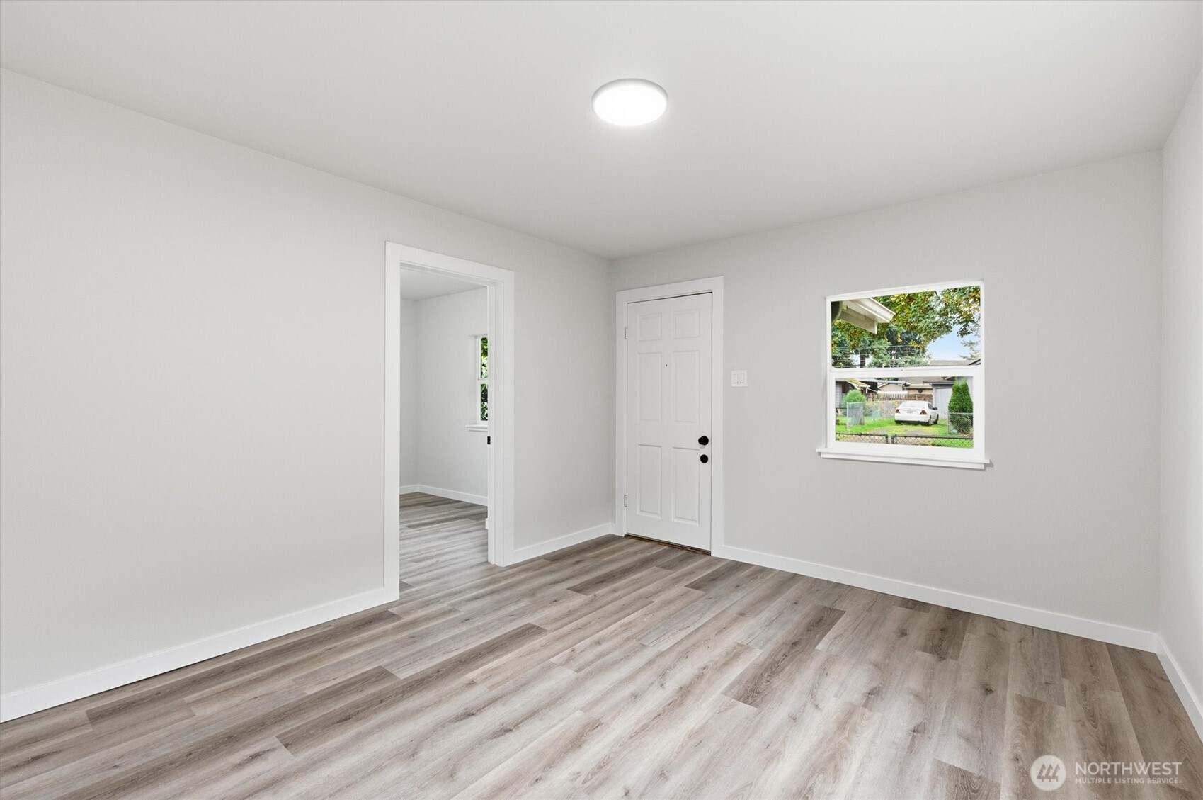 289 20th Avenue Longview, WA 98632 - Photo 6 of 38 an empty room with wooden floor and windows