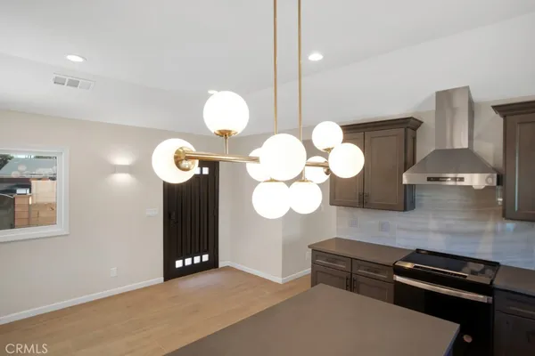 a kitchen with stove and cabinets