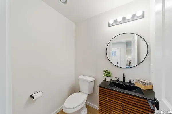 a bathroom with a toilet a sink and a mirror