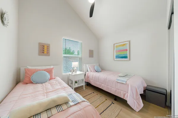 a bedroom with a bed and painting on the wall