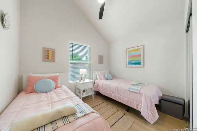 a bedroom with a bed and painting on the wall