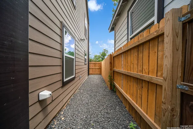 a view of a balcony with wooden floor and fence