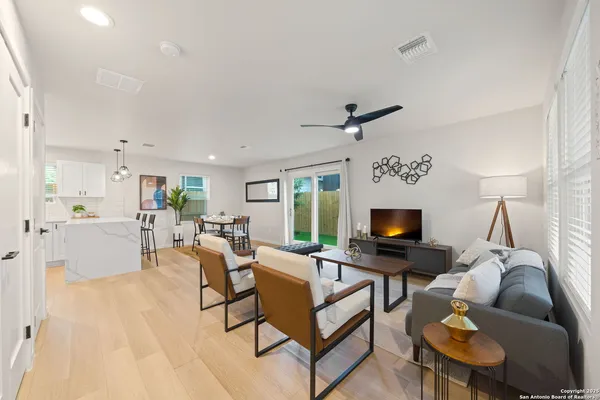 a living room with furniture a fireplace and a flat screen tv