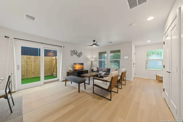 a living room with furniture and a wooden floor