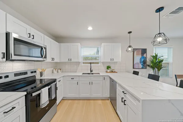 a kitchen with a sink stove and microwave