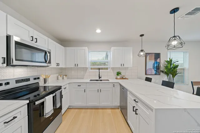 a kitchen with a sink stove and microwave