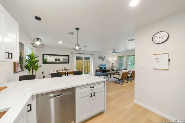 a kitchen with a sink a stove and chairs