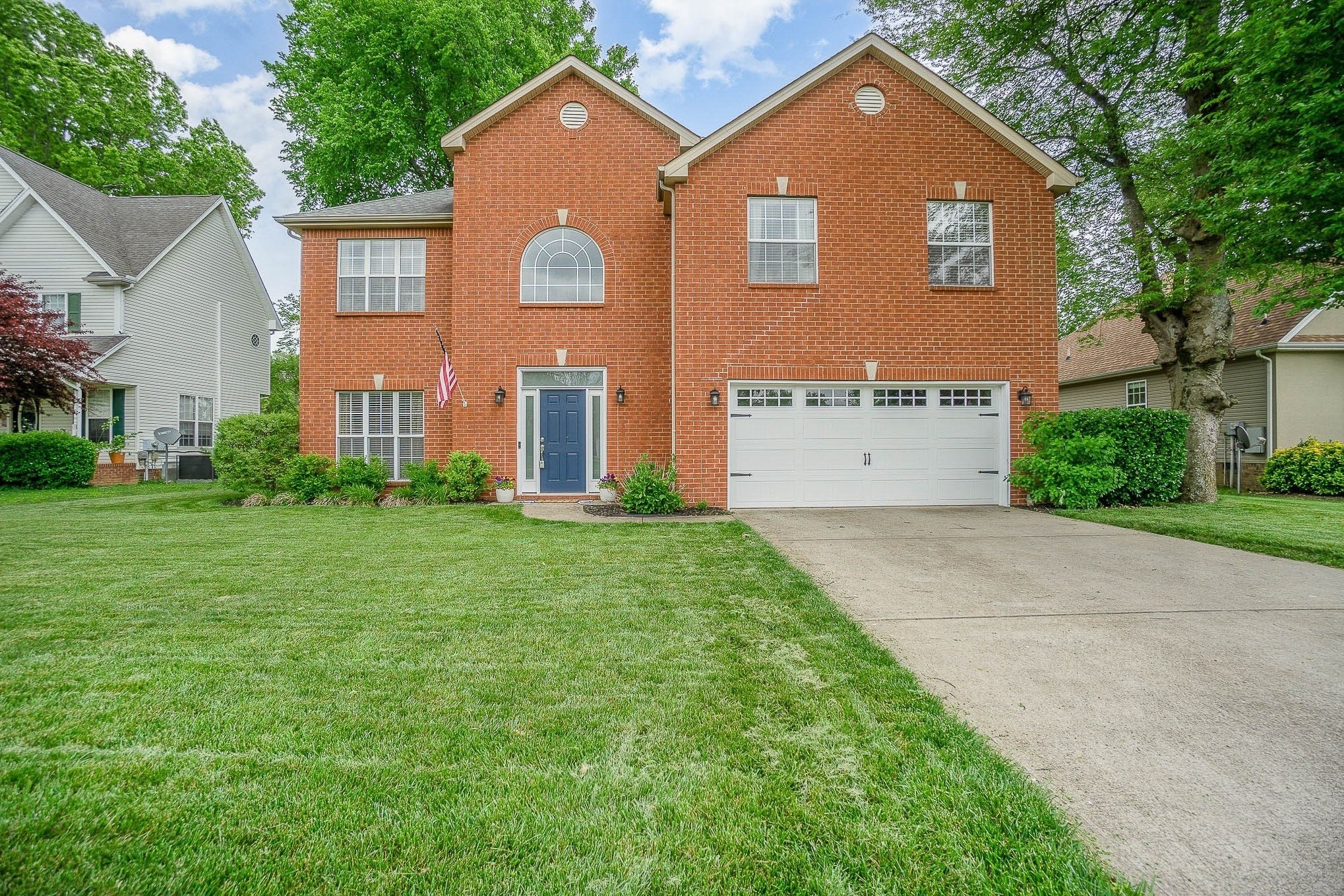1990 Portway Road Spring Hill, TN 37174 - Photo 1 of 19 a front view of a house with a yard and garage