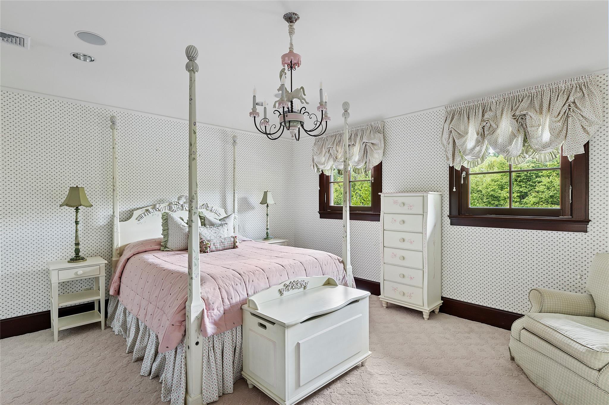 5 Half Moon Lane Sands Point, NY 11050 - Photo 21 of 35 a bedroom with a bed chandelier and window