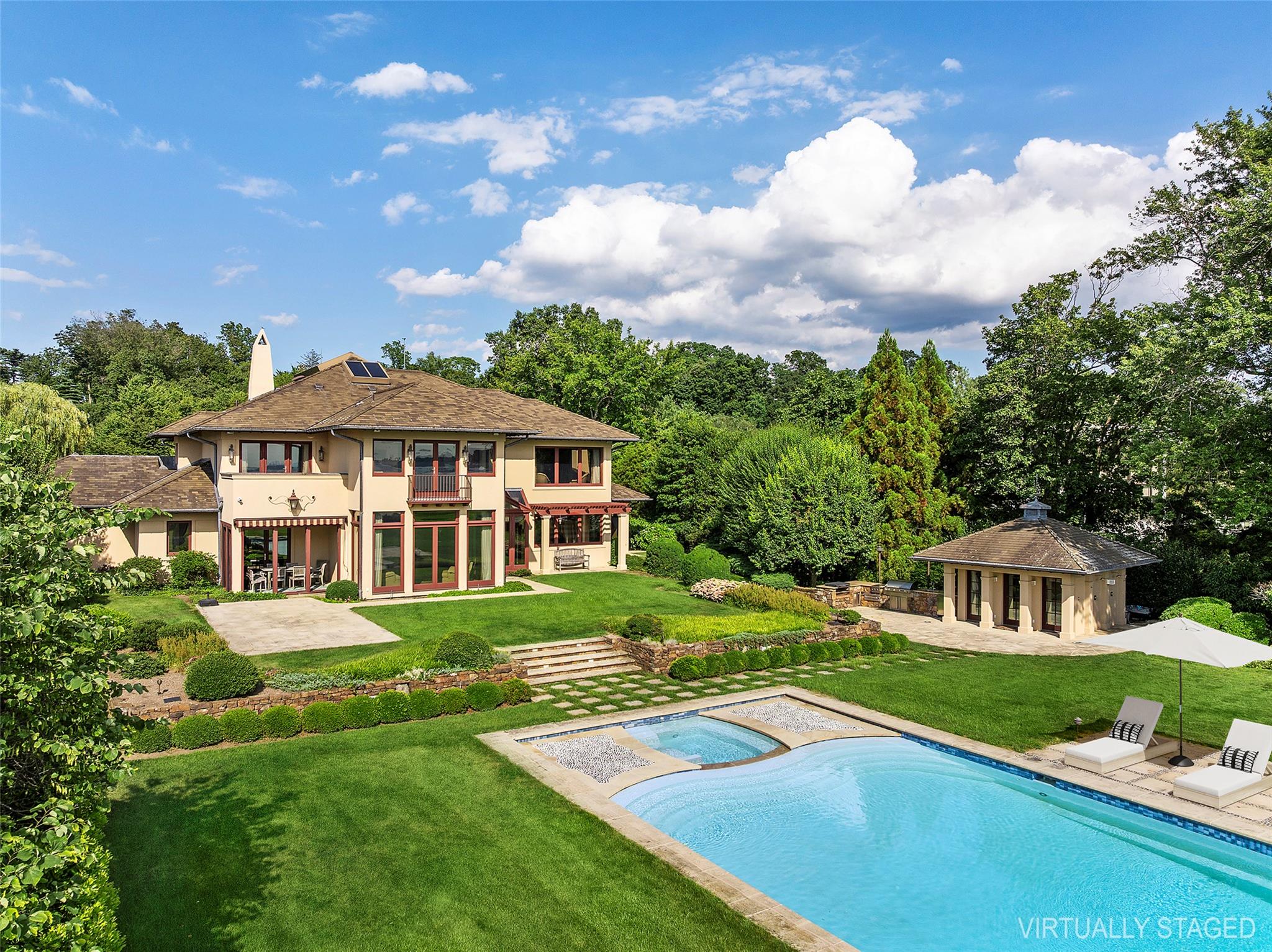 5 Half Moon Lane Sands Point, NY 11050 - Photo 23 of 35 a front view of a house with a yard table and chairs