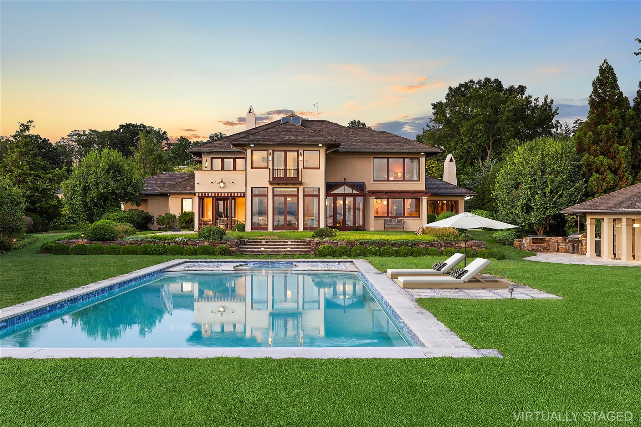 5 Half Moon Lane Sands Point, NY 11050 - Photo 30 of 35 a front view of a house with a yard table and chairs