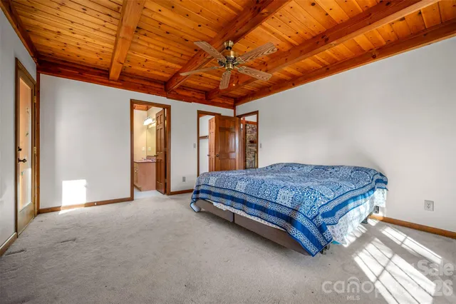 a spacious bedroom with a bed and a chandelier