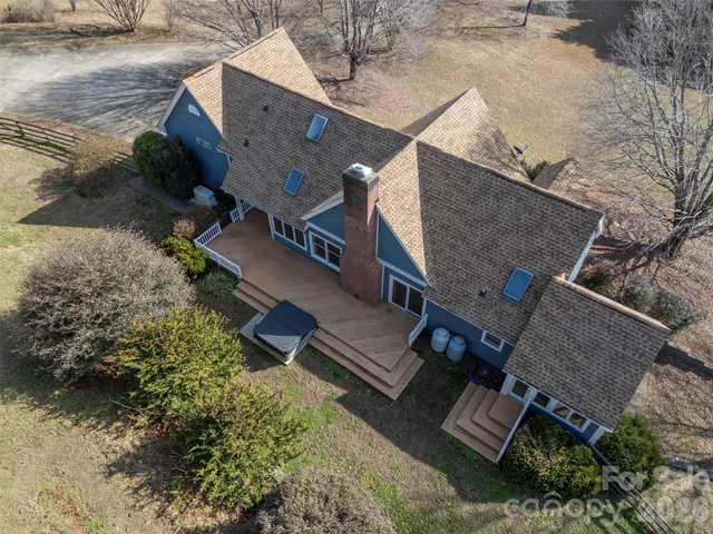 a view of a yard with wooden fence