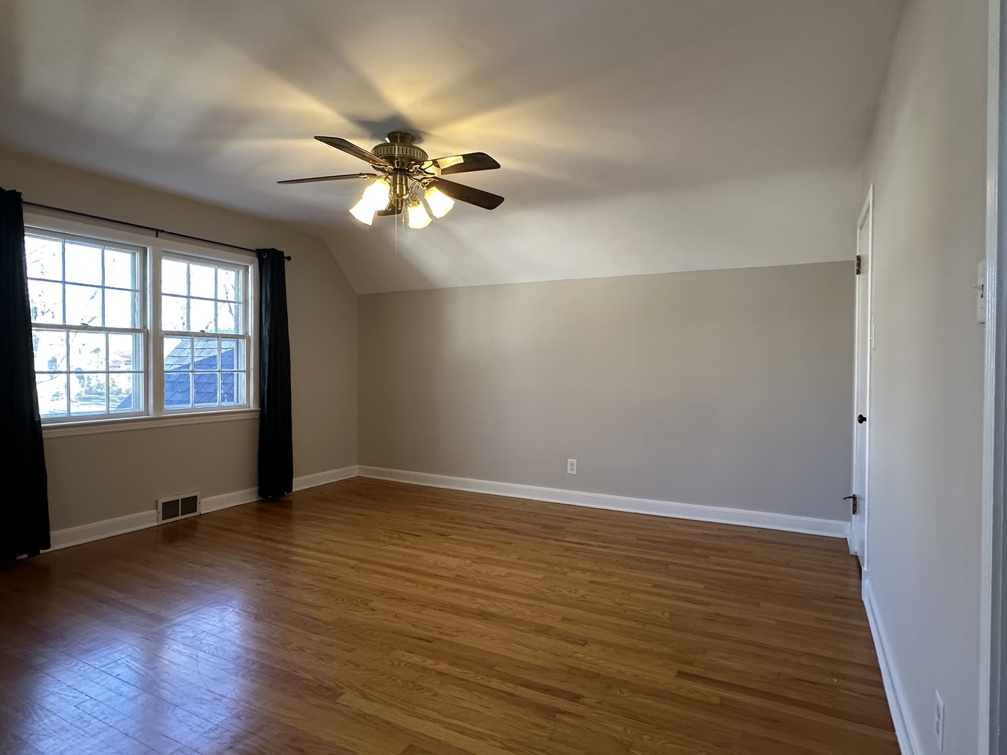 1195 South Myrtle Avenue Kankakee, IL 60901 - Photo 20 of 38 an empty room with wooden floor fan and windows